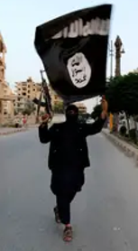 Islamic State militant with a flag