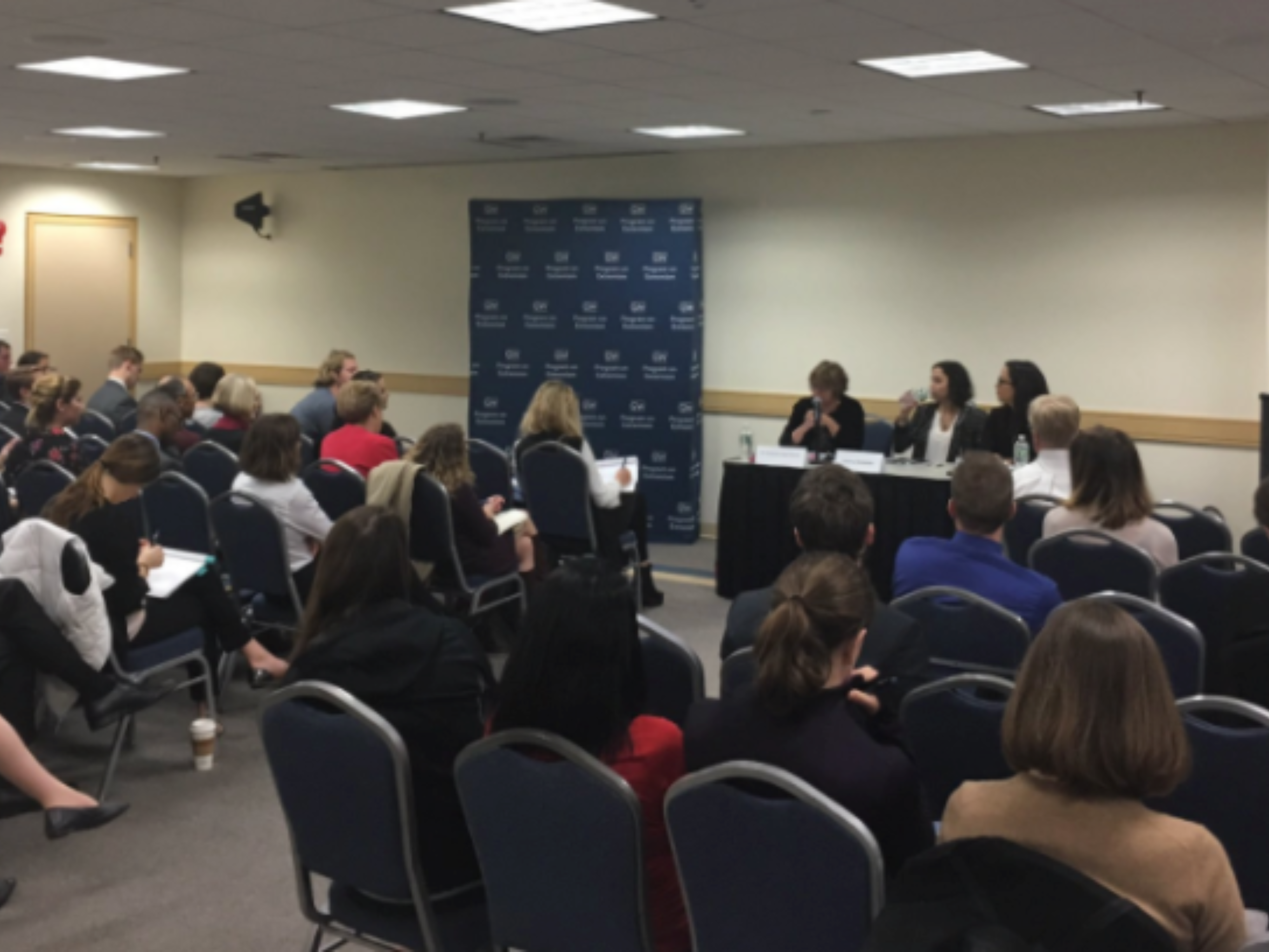 An image of the audience and panel at Women in Terrorism: A Year After San Bernardino.