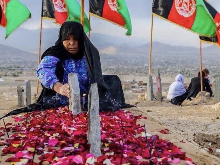 Hazara woman at grave of her child